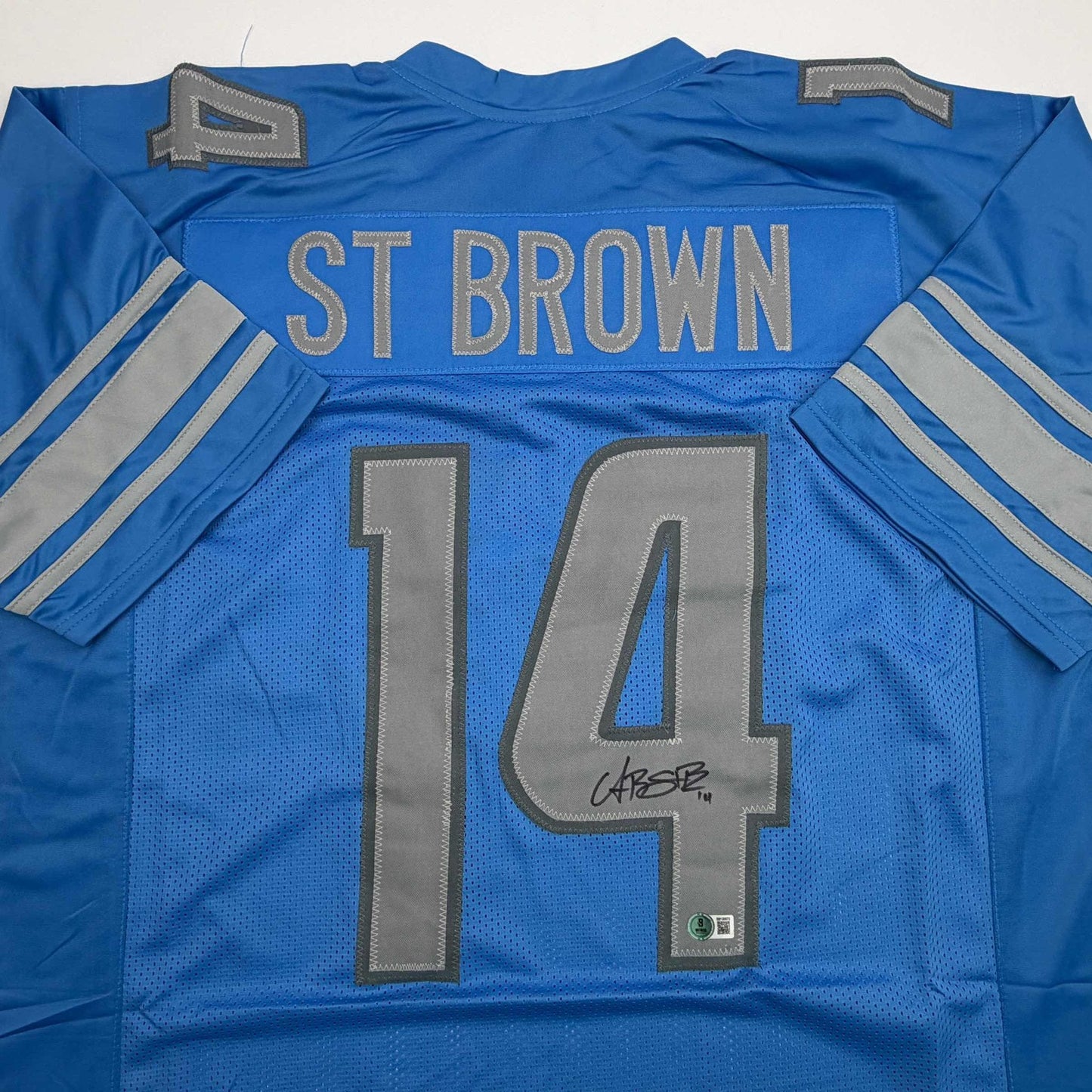 Autographed/Signed Amon-Ra St. Brown Detroit Blue Football Jersey Beckett BAS COA