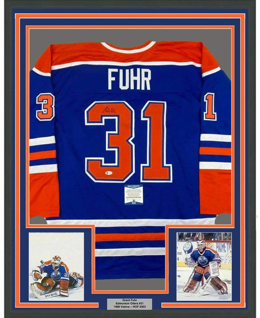 Framed Autographed/Signed Grant Fuhr 35x39 Edmonton Blue Hockey Jersey Beckett BAS COA - Golden Apple Comics