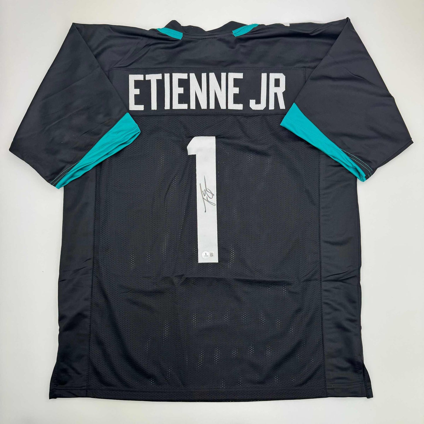 Autographed/Signed Travis Etienne Jr. Jacksonville Black Football Jersey Beckett BAS COA